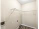 Clean laundry room with wire shelving, neutral paint, and durable wood-look flooring at 300 Radner Run, Lawrenceville, GA 30043