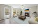Inviting living room features a fireplace, mounted television, a ceiling fan, and plenty of natural light at 300 Radner Run, Lawrenceville, GA 30043