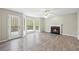 Bright living room with wood floors, fireplace, bay window, and access to outdoor deck at 300 Radner Run, Lawrenceville, GA 30043