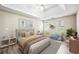Staged main bedroom with tray ceilings, soft lighting, and sitting area at 300 Radner Run, Lawrenceville, GA 30043