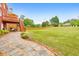 Expansive backyard view showing a lush lawn, stone pathway, and well-manicured landscaping at 3311 Keenland Rd, Marietta, GA 30062