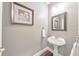 Cozy powder room showcasing pedestal sink, framed mirror, and neutral wall color at 3311 Keenland Rd, Marietta, GA 30062