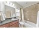 Bathroom featuring dark wood cabinets, granite countertop and a shower-tub combination at 3311 Keenland Rd, Marietta, GA 30062