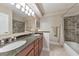 Bathroom featuring double sinks, granite countertop, and tiled shower and floors at 3311 Keenland Rd, Marietta, GA 30062
