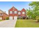 Beautiful two-story brick home with a well-manicured lawn and two-car garage at 3311 Keenland Rd, Marietta, GA 30062