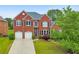 Charming two-story brick home with a well-manicured lawn and two-car garage at 3311 Keenland Rd, Marietta, GA 30062