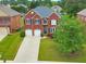 Charming brick home featuring a two-car garage and well-manicured front lawn at 3311 Keenland Rd, Marietta, GA 30062