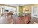 Kitchen island with granite countertop and stainless cooktop, with seating, open to living areas and abundant natural light at 3311 Keenland Rd, Marietta, GA 30062