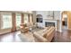 Inviting living room with a fireplace, tall windows, and hardwood floors, perfect for relaxation and entertaining guests at 3311 Keenland Rd, Marietta, GA 30062