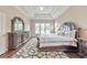 Spacious main bedroom featuring a decorative tray ceiling, large windows and luxury furniture at 3311 Keenland Rd, Marietta, GA 30062