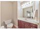 Powder room with dark wood cabinets, light walls, and hardwood floors at 3311 Keenland Rd, Marietta, GA 30062