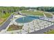 Aerial view of a park featuring a pond, bridge, and walking paths at 3932 Boston Common St, Suwanee, GA 30024