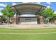 Outdoor amphitheater with a stage and seating surrounded by green lawn at 3932 Boston Common St, Suwanee, GA 30024
