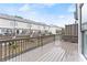 Back deck with brown wood planks overlooks townhome community and backyard at 3932 Boston Common St, Suwanee, GA 30024