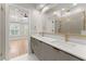 Modern bathroom featuring double vanity, gold fixtures, herringbone-tile shower, and bedroom access at 3932 Boston Common St, Suwanee, GA 30024