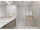 Modern bathroom featuring double vanity with gold hardware and a spacious glass shower at 3932 Boston Common St, Suwanee, GA 30024