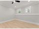 Bedroom featuring hardwood floors, recessed lights, and two windows at 3932 Boston Common St, Suwanee, GA 30024