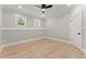 Bedroom featuring light hardwood flooring, base molding, and windows at 3932 Boston Common St, Suwanee, GA 30024