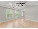 Bright, airy bedroom featuring a vaulted ceiling, recessed lighting, and large windows with green views at 3932 Boston Common St, Suwanee, GA 30024
