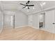 Bright bedroom features light hardwood floors, an elegant ceiling fan, and access to the ensuite bathroom at 3932 Boston Common St, Suwanee, GA 30024