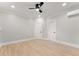 Bright bedroom with light hardwood floors, fan and white trim throughout at 3932 Boston Common St, Suwanee, GA 30024