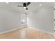 Bright bedroom with hardwood floors, ceiling fan, and window view at 3932 Boston Common St, Suwanee, GA 30024