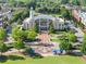 Aerial view of Suwanee City Hall surrounded by lush trees, shops, and community at 3932 Boston Common St, Suwanee, GA 30024