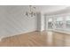 Bright dining area with stylish light fixture, accent wall, and backyard view at 3932 Boston Common St, Suwanee, GA 30024