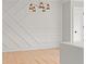 Dining room with decorative wall with linear design with modern chandelier at 3932 Boston Common St, Suwanee, GA 30024