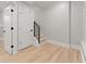 Hallway featuring hardwood floors, stairs, and multiple entryways at 3932 Boston Common St, Suwanee, GA 30024