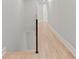 Hallway with hardwood floors and black railing and open stairway at 3932 Boston Common St, Suwanee, GA 30024