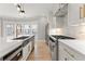 Modern kitchen featuring stainless steel appliances and an island with a sink and white countertop at 3932 Boston Common St, Suwanee, GA 30024