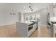 Bright kitchen boasts a large island, stainless steel appliances, and modern lighting fixtures at 3932 Boston Common St, Suwanee, GA 30024