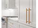 Kitchen details showcasing white cabinets with gold hardware and stainless steel appliances at 3932 Boston Common St, Suwanee, GA 30024