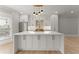 Bright, modern kitchen with a large island, white cabinets, and gold hardware at 3932 Boston Common St, Suwanee, GA 30024