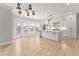 Open concept kitchen with island and stainless steel appliances and adjacent living space at 3932 Boston Common St, Suwanee, GA 30024
