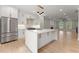 This kitchen features a spacious island, stainless steel appliances, and open layout to living area at 3932 Boston Common St, Suwanee, GA 30024