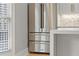 Close-up of stainless steel refrigerator and white kitchen cabinets with designer backsplash at 3932 Boston Common St, Suwanee, GA 30024