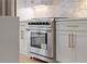Stainless steel range with oven set into shaker style cabinets and modern backsplash at 3932 Boston Common St, Suwanee, GA 30024