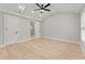 Spacious main bedroom with hardwood floors and light grey walls and tray ceiling at 3932 Boston Common St, Suwanee, GA 30024