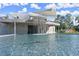Modern pool with an overhead gazebo structure, cascading waterfall feature, and comfortable seating areas at 3932 Boston Common St, Suwanee, GA 30024
