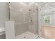 Modern shower with herringbone tile, a built-in seat, and a glass door at 3932 Boston Common St, Suwanee, GA 30024
