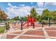 Town square with red art installation, manicured plants, and walkable sidewalks at 3932 Boston Common St, Suwanee, GA 30024