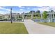 View of park's walking bridge spanning water feature, with modern art installation, and landscaping at 3932 Boston Common St, Suwanee, GA 30024