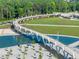 A charming walking bridge spans a tranquil pond in a park, surrounded by lush trees and manicured landscapes at 3932 Boston Common St, Suwanee, GA 30024
