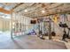 Spacious unfinished basement framed for a workout area with fitness equipment and a rubber floor at 412 Nickajack Retreat Ln, Smyrna, GA 30082