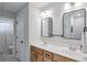 Modern bathroom with double sinks, sleek mirrors, light wood cabinets, and stylish lighting fixtures at 412 Nickajack Retreat Ln, Smyrna, GA 30082