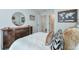Comfortable bedroom featuring a round mirror, brown dresser, and tasteful animal print decor at 412 Nickajack Retreat Ln, Smyrna, GA 30082