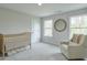Serene Bedroom with a crib, comfy chair, neutral tones, and lots of natural light from two windows at 412 Nickajack Retreat Ln, Smyrna, GA 30082