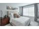 Bright bedroom with a tufted headboard, bedside table, and light gray walls and trim at 412 Nickajack Retreat Ln, Smyrna, GA 30082